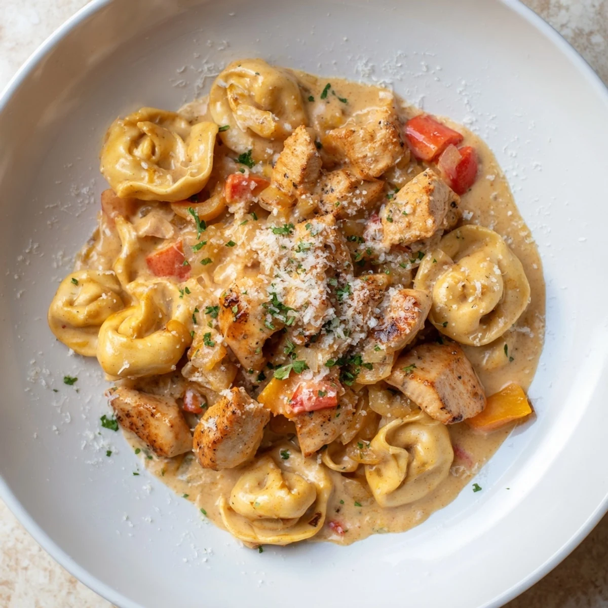 Creamy Zesty Cajun Garlic Parmesan Chicken Tortellini, a flavorful pasta dish with herbs and fresh Parmesan.