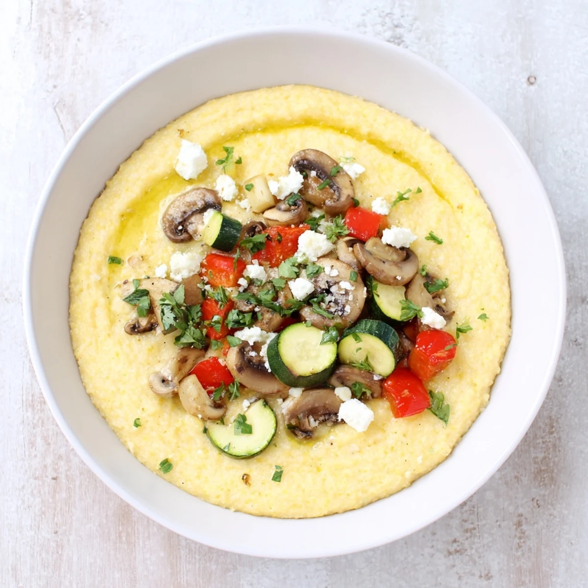 Warm, creamy Cornmeal Mush Polenta Bowls, brimming with sauteed mushrooms and a drizzle of olive oil.