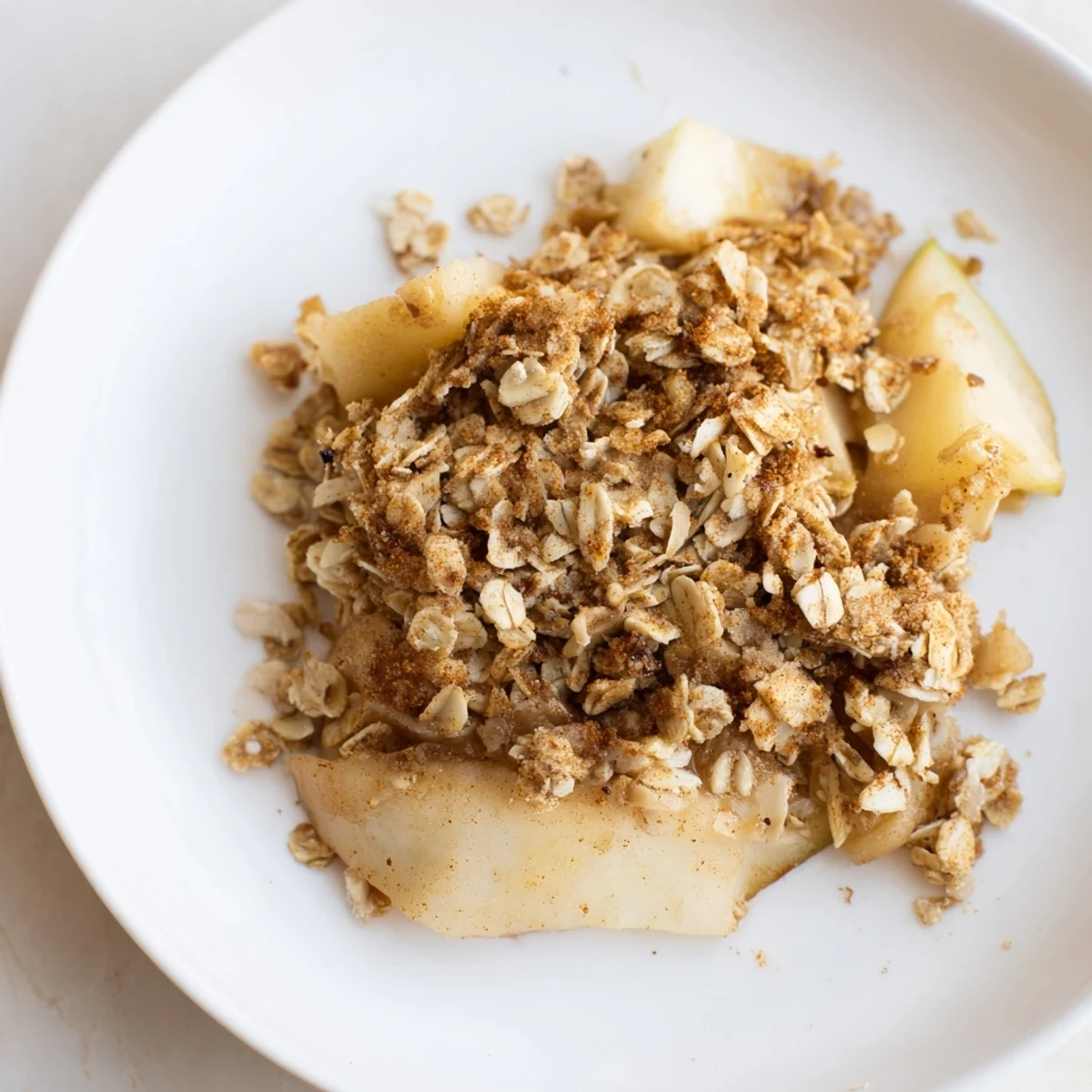 Enjoy a comforting bowl of Best Apple Crisp: bubbling fruit covered in a golden brown crisp.