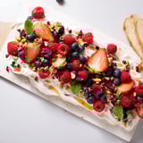 Decadent Butter Board Dessert topped with vibrant berries and crunchy nuts for sharing.  