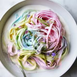 Vibrant Neon Noodle Cloud glistening in a whimsical creamy sauce, perfect for gatherings.  