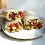 Colorful plant-based dish showcasing marinated tofu, drizzled with creamy tahini-yogurt sauce.  