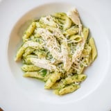 A close-up of creamy 10-Minute Pesto Pasta with Chicken, showcasing juicy rotisserie chicken pieces within.