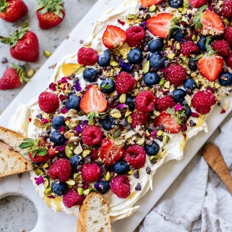 A beautifully arranged Butter Board Dessert featuring whipped cream cheese and fresh berries.  