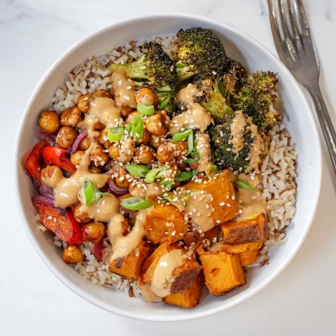Vibrant Bold Sauce Drizzle Bowls topped with colorful roasted vegetables and chickpeas.  