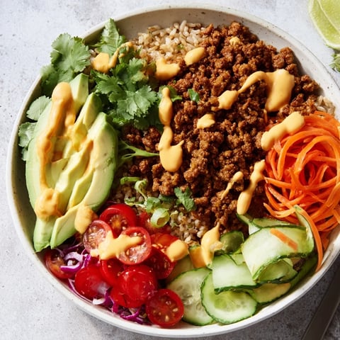A colorful plant-based meat bowl topped with fresh veggies and vibrant flavors.  