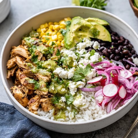 A colorful Green Enchiladas Rice Bowl topped with fresh avocado and cilantro.  