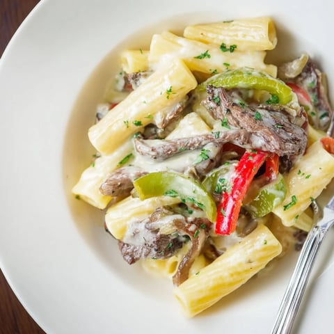 A creamy Philly Cheese Steak Pasta dish with tender beef and colorful peppers.  