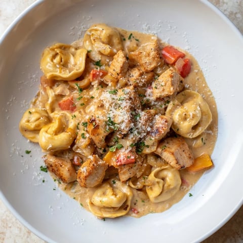 Creamy Zesty Cajun Garlic Parmesan Chicken Tortellini, a flavorful pasta dish with herbs and fresh Parmesan.