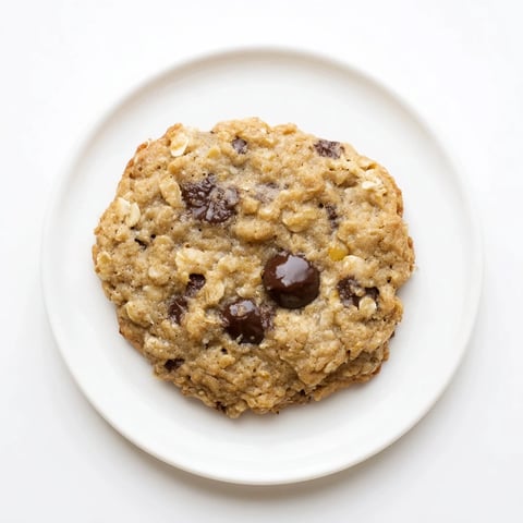 Warm, golden Oat-Banana Chocolate Chip Cookies, fresh from the oven, ready to enjoy with a glass of milk.