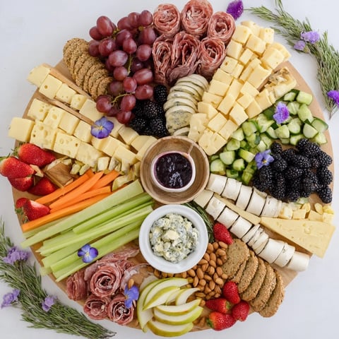 Enchanted Forest grazing board with colorful fruits, cheeses, and charcuterie, ready to enjoy.