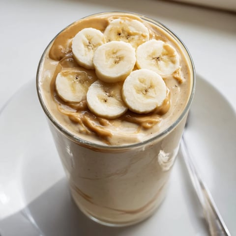Thick peanut butter banana smoothie, swirled with a creamy texture, ready to revitalise your morning.