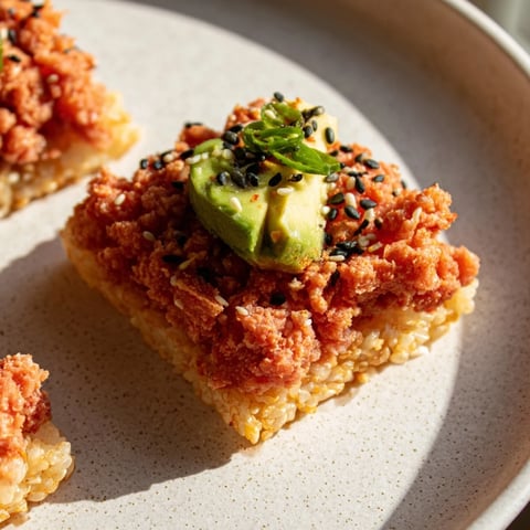 Golden, fried Spicy Tuna Crispy Rice appetizers are topped with creamy spicy tuna, ready to eat.