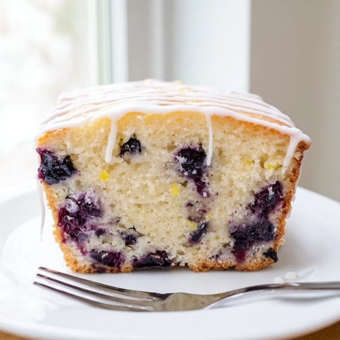 Golden, moist Lemon Blueberry Yogurt Loaf, studded with plump blueberries, ready for a sweet bite.