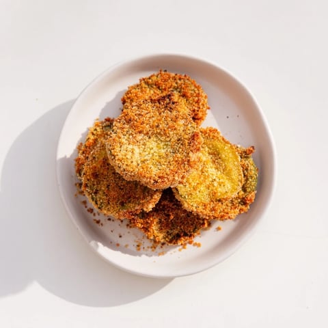 Golden-brown, crispy fried pickles: a perfect appetizer served with cool, creamy ranch dip.