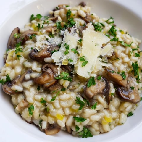 Creamy Italian Mushroom Risotto, topped with fresh parsley and Parmesan cheese, ready to serve.