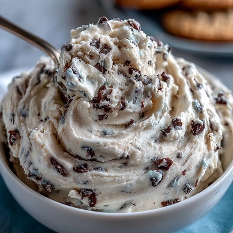 Creamy Greek yogurt cookie dough with mini chocolate chips in a bowl, perfect for a healthy no-bake snack.
