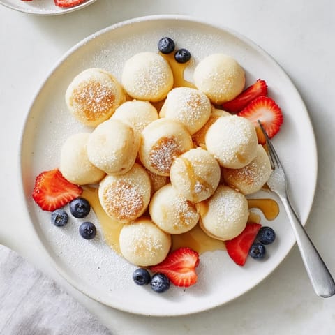 Deliciously chewy mochi pancake bites served warm with powdered sugar dusting.  