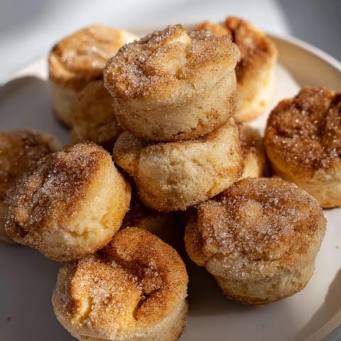 Deliciously fluffy churro muffin scone bites topped with a sweet cinnamon sugar coating.  