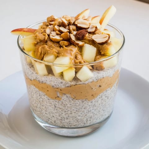 Delicious Apple-Chia Pudding features a swirl of peanut butter and sweet apple, ready to eat!