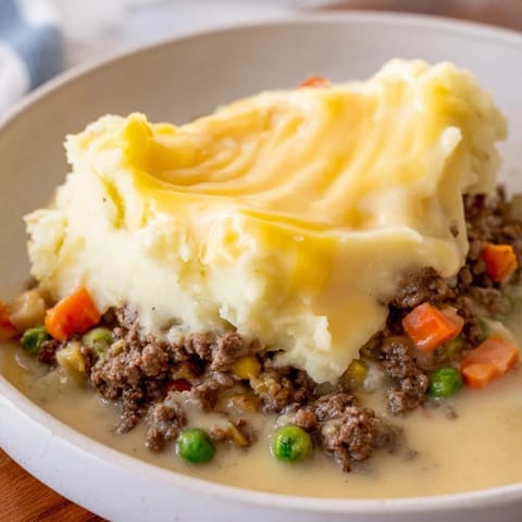 Savory ground beef filling is topped by cheesy mashed potatoes in this Budget Shepherd's Pie.