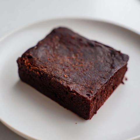 These decadent Pumpkin Workout Brownies look rich, dark, and perfectly cut, ready for a post-workout recovery snack.