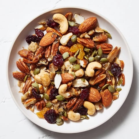 Up close, a hearty serving of Nutty Nosh Squirrel Snack Mix shows the perfectly toasted nuts and seeds.