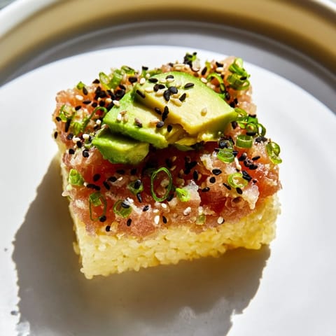 Perfectly formed Spicy Tuna Crispy Rice, a Japanese-American fusion, featuring a creamy tuna topping.