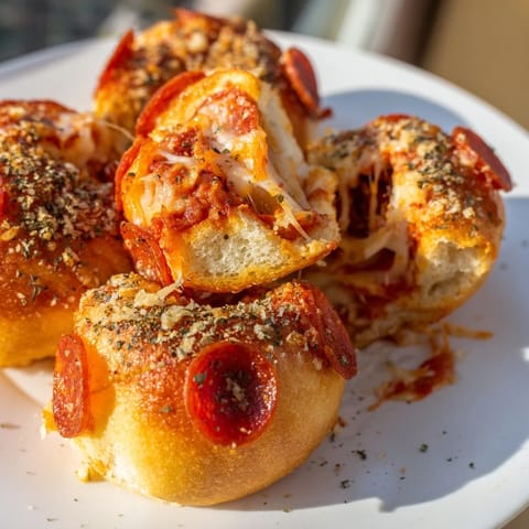 Freshly baked, bite-sized air fryer pizza rolls with melted cheese and pepperoni inside.