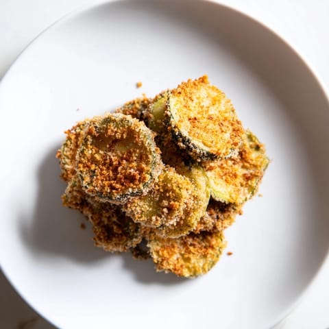Air-fried crispy fried pickles, boasting a crunchy breading and savory dill flavor, ready to enjoy.