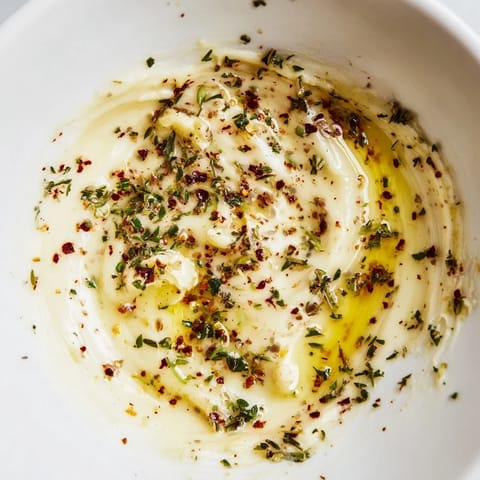 A close-up of creamy, flavorful Cowboy Butter Sauce, swirled in a small pan, perfect for dipping.