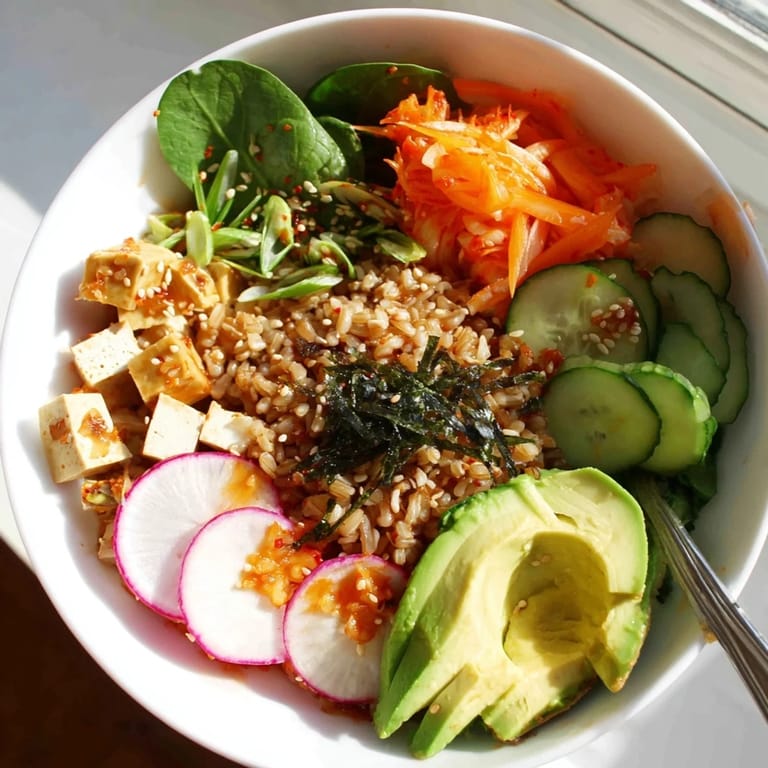 Vibrant fermented vegetable bowl showcasing tangy kimchi, fresh greens, and avocado slices.  