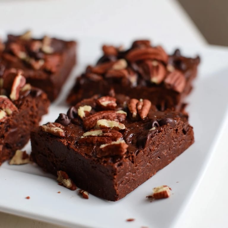 Warm sweet potato brownies, square-cut and fudgy, ready to be enjoyed with a cold glass of milk.
