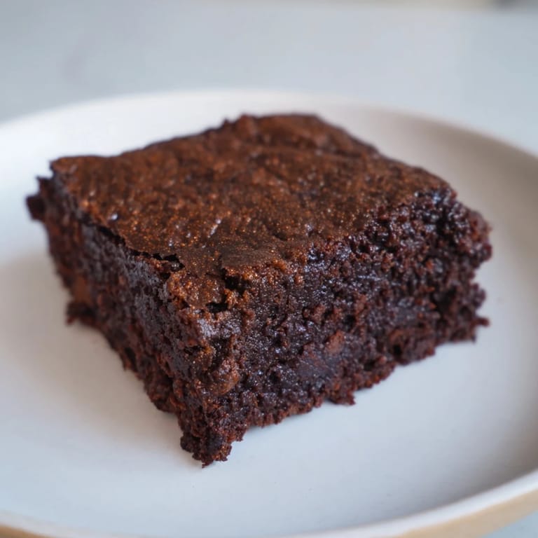 A close-up of delicious Pumpkin Workout Brownies—a gluten-free, dairy-free dessert with a moist, fudgy texture.