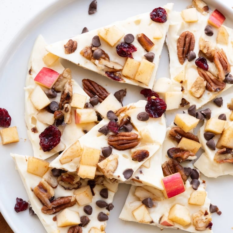 This frozen Apple Cinnamon Yogurt Bark reveals a colorful, healthy snack with fresh apple pieces.