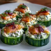 Cucumber Bites with Cream Cheese and Smoked Salmon, an elegant appetizer with creamy dill topping and savory smoked salmon.